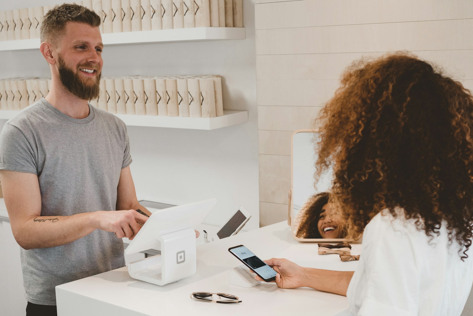 A customer paying by card at a city storefront counter